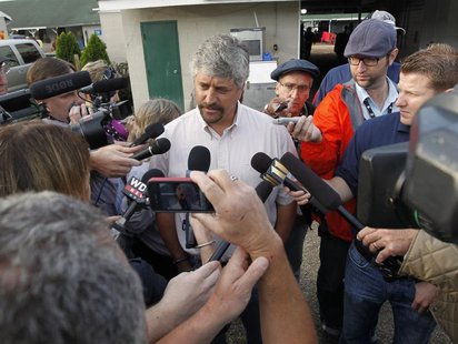 Trainer Steve Asmussen (C) talks about his horses, Kentucky Derby hopefuls Daddy Nose Best and Sabercat, after early morning workout at Chur Trainer Steve Asmussen (C) talks about his horses, Kentucky Derby hopefuls Daddy Nose Best and Sabercat, after early morning workout at Chur
