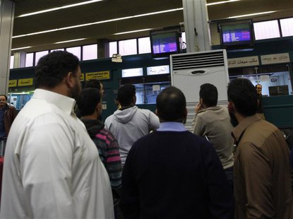 Passengers look at a flight information monitor after the reopening of the airport in Tripoli March 21, 2014. REUTERS/Ismail Zitouny Passengers look at a flight information monitor after the reopening of the airport in Tripoli March 21, 2014. REUTERS/Ismail Zitouny