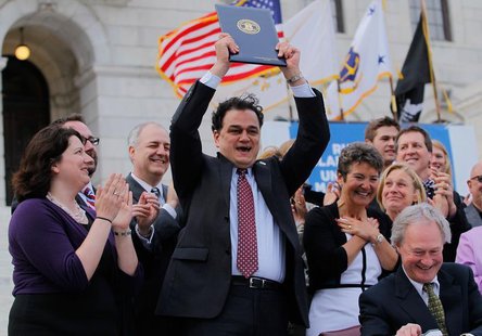 Speaker Gordon Fox (C) holds up the Marriage Equality Act at the State House in Providence, Rhode Island, May 2, 2013. REUTERS/Jessica Rinal Speaker Gordon Fox (C) holds up the Marriage Equality Act at the State House in Providence, Rhode Island, May 2, 2013. REUTERS/Jessica Rinal