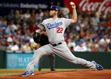 Los Angeles Dodgers pitcher Clayton Kershaw delivers a pitch against the Arizona Diamondbacks during the opening innings of the opening game Los Angeles Dodgers pitcher Clayton Kershaw delivers a pitch against the Arizona Diamondbacks during the opening innings of the opening game