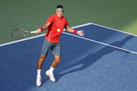 Juan Martin Del Potro of Argentina returns the ball to Somdev Devvarman of India during their men's singles match at the ATP Dubai Tennis Ch Juan Martin Del Potro of Argentina returns the ball to Somdev Devvarman of India during their men's singles match at the ATP Dubai Tennis Ch