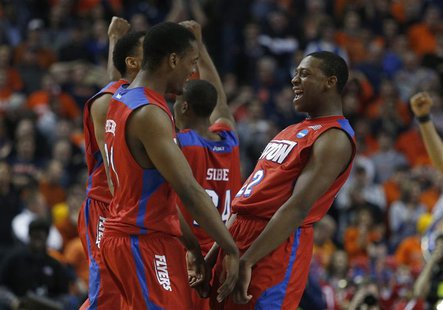 Mar 22, 2014; Buffalo, NY, USA; Dayton Flyers forward Dyshawn Pierre (21) and Dayton Flyers forward Kendall Pollard (22) celebrate beating t Mar 22, 2014; Buffalo, NY, USA; Dayton Flyers forward Dyshawn Pierre (21) and Dayton Flyers forward Kendall Pollard (22) celebrate beating t