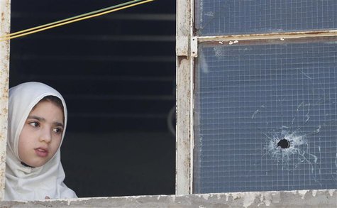 A girl looks out of a window after clashes in south Beirut March 23, 2014. REUTERS/Mohamed Azakir A girl looks out of a window after clashes in south Beirut March 23, 2014. REUTERS/Mohamed Azakir