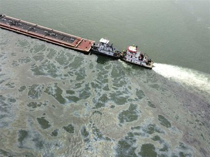 A barge loaded with marine fuel oil sits partially submerged in the Houston Ship Channel in this U.S. Coast Guard picture taken March 22, 20 A barge loaded with marine fuel oil sits partially submerged in the Houston Ship Channel in this U.S. Coast Guard picture taken March 22, 20