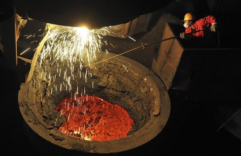 An employee works above a furnace containing molten steel at a factory of Dongbei Special Steel Group Co. Ltd. in Dalian, Liaoning province An employee works above a furnace containing molten steel at a factory of Dongbei Special Steel Group Co. Ltd. in Dalian, Liaoning province