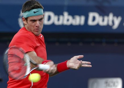 Juan Martin Del Potro of Argentina returns the ball to Somdev Devvarman of India during their men's singles match at the ATP Dubai Tennis Ch Juan Martin Del Potro of Argentina returns the ball to Somdev Devvarman of India during their men's singles match at the ATP Dubai Tennis Ch