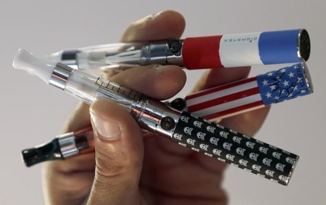 A salesman displays electronic cigarettes during the first international fair of electronic cigarette and vapology "Vapexpo" in Bordeaux, so A salesman displays electronic cigarettes during the first international fair of electronic cigarette and vapology "Vapexpo" in Bordeaux, so