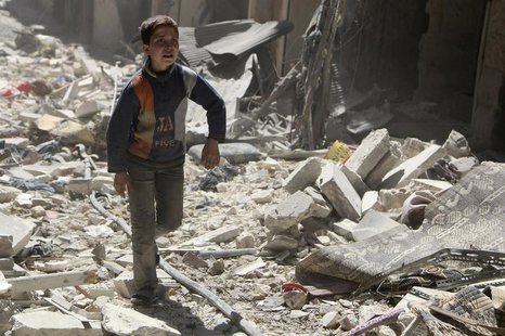 A boy walks on rubble of damaged buildings at a site hit by what activists said was an airstrike by forces loyal to Syria's President Bashar A boy walks on rubble of damaged buildings at a site hit by what activists said was an airstrike by forces loyal to Syria's President Bashar