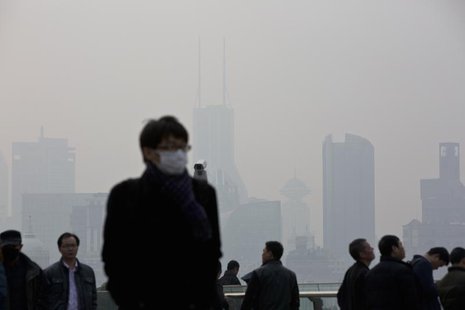 A man wearing a face mask walks through the Lujiazui financial district of Pudong on a hazy day in Shanghai, March 10, 2014. REUTERS/Aly Son A man wearing a face mask walks through the Lujiazui financial district of Pudong on a hazy day in Shanghai, March 10, 2014. REUTERS/Aly Son