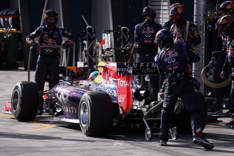 Red Bull Formula One driver Sebastian Vettel of Germany is assisted by his pit crew as he retires from the Australian F1 Grand Prix at the A Red Bull Formula One driver Sebastian Vettel of Germany is assisted by his pit crew as he retires from the Australian F1 Grand Prix at the A