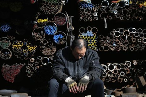 A worker takes a nap in front of steel products stacked at a steelworks in Seoul January 28, 2014. REUTERS/Kim Hong-Ji A worker takes a nap in front of steel products stacked at a steelworks in Seoul January 28, 2014. REUTERS/Kim Hong-Ji