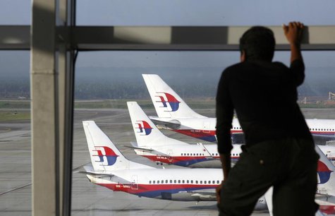 A traveller stands at the viewing gallery overlooking Malaysian Airline System (MAS) aircrafts at Kuala Lumpur International Airport in Sepa A traveller stands at the viewing gallery overlooking Malaysian Airline System (MAS) aircrafts at Kuala Lumpur International Airport in Sepa