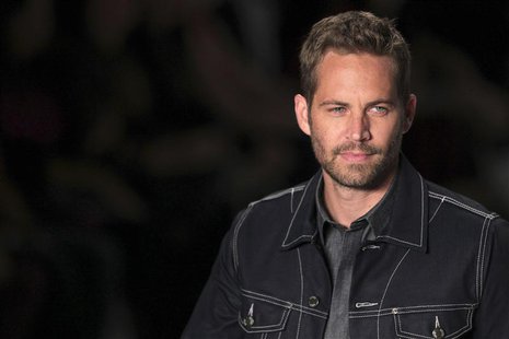 U.S. actor Paul Walker presents a creation from Colcci's 2013/2014 summer collection during Sao Paulo Fashion Week in this March 21, 2013 fi U.S. actor Paul Walker presents a creation from Colcci's 2013/2014 summer collection during Sao Paulo Fashion Week in this March 21, 2013 fi