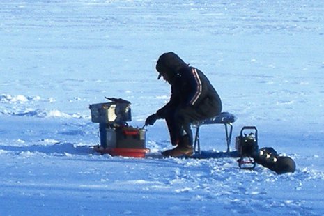 A person ice fishing. A person ice fishing.