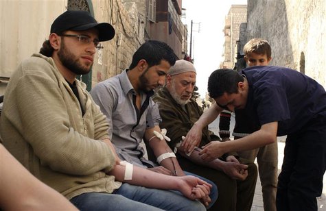 Men donate blood during a campaign to supply blood to field hospitals in Aleppo March 23, 2014. REUTERS/Abdalrhman Ismail Men donate blood during a campaign to supply blood to field hospitals in Aleppo March 23, 2014. REUTERS/Abdalrhman Ismail