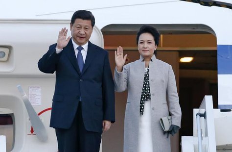 China's President Xi Jinping (L) and his wife Peng Liyuan wave as they arrive at the Lyon-Saint-Exupery airport in Colombier-Saugnieu, near China's President Xi Jinping (L) and his wife Peng Liyuan wave as they arrive at the Lyon-Saint-Exupery airport in Colombier-Saugnieu, near