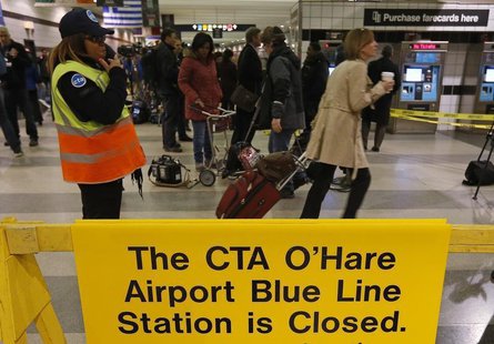 A Chicago Transit Authority worker directs commuters to a shuttle bus after a subway train derailed at O'Hare International Airport in Chica A Chicago Transit Authority worker directs commuters to a shuttle bus after a subway train derailed at O'Hare International Airport in Chica