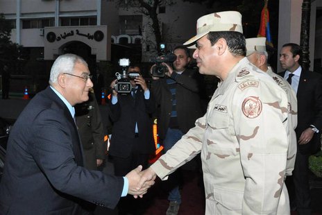 Egypt's interim President Adly Mansour (L) shakes hands with Egypt's army chief Field Marshal Abdel Fattah al-Sisi (R), after his meeting wi Egypt's interim President Adly Mansour (L) shakes hands with Egypt's army chief Field Marshal Abdel Fattah al-Sisi (R), after his meeting wi