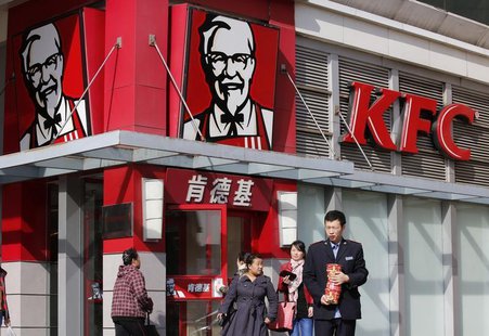 A man holds instant noodle packs in front of a KFC restaurant in Beijing October 23, 2013. REUTERS/Kim Kyung-Hoon A man holds instant noodle packs in front of a KFC restaurant in Beijing October 23, 2013. REUTERS/Kim Kyung-Hoon