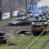 A Russian soldier (L) guides a Ukrainian tank, which is to be loaded onto a train, in northern Crimea March 27, 2014. REUTERS/Yannis Behraki A Russian soldier (L) guides a Ukrainian tank, which is to be loaded onto a train, in northern Crimea March 27, 2014. REUTERS/Yannis Behraki