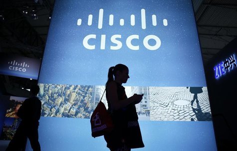 A visitor walks past a Cisco advertising panel as she looks at her mobile phone at the Mobile World Congress in Barcelona February 27, 2014. A visitor walks past a Cisco advertising panel as she looks at her mobile phone at the Mobile World Congress in Barcelona February 27, 2014.