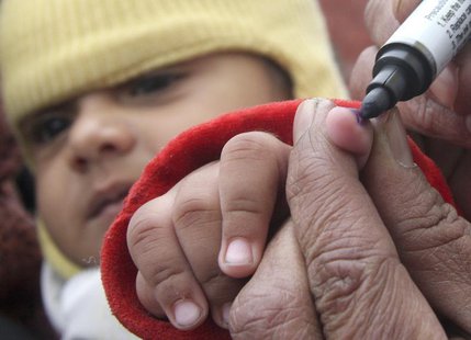 A health worker marks the finger of a child after administering a polio vaccine at a polio booth in the northern Indian city of Chandigarh J A health worker marks the finger of a child after administering a polio vaccine at a polio booth in the northern Indian city of Chandigarh J