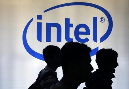 Indonesian youth walk past an Intel sign during Digital Imaging expo in Jakarta March 5, 2014. REUTERS/Beawiharta Indonesian youth walk past an Intel sign during Digital Imaging expo in Jakarta March 5, 2014. REUTERS/Beawiharta