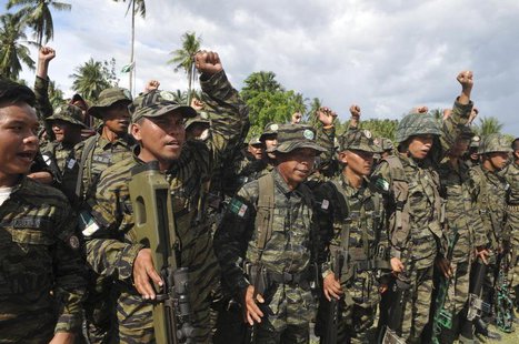 Moro Islamic Liberation Front (MILF) forces raise their fists during a show of force inside the camp in Camp Darapanan, Maguindanao province Moro Islamic Liberation Front (MILF) forces raise their fists during a show of force inside the camp in Camp Darapanan, Maguindanao province