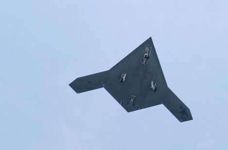 An X-47B pilot-less drone combat aircraft flies over the deck of the USS George H.W. Bush aircraft carrier in the Atlantic Ocean off the coa An X-47B pilot-less drone combat aircraft flies over the deck of the USS George H.W. Bush aircraft carrier in the Atlantic Ocean off the coa
