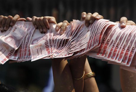 Anti-government protesters hold Thai baht banknotes to donate to protest leader Suthep Thaugsuban (unseen) as he leads a march through centr Anti-government protesters hold Thai baht banknotes to donate to protest leader Suthep Thaugsuban (unseen) as he leads a march through centr