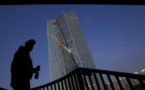 An American tourist stands under a bridge as he looks at the construction site of the new European Central Bank (ECB) headquarters in Frankf An American tourist stands under a bridge as he looks at the construction site of the new European Central Bank (ECB) headquarters in Frankf