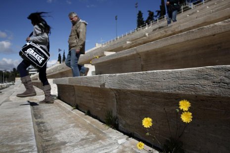 Tourists visit the Panathenean stadium, the stadium which hosted the first modern Olympics in 1896, in Athens March 11, 2014. REUTERS/Yorgos Tourists visit the Panathenean stadium, the stadium which hosted the first modern Olympics in 1896, in Athens March 11, 2014. REUTERS/Yorgos