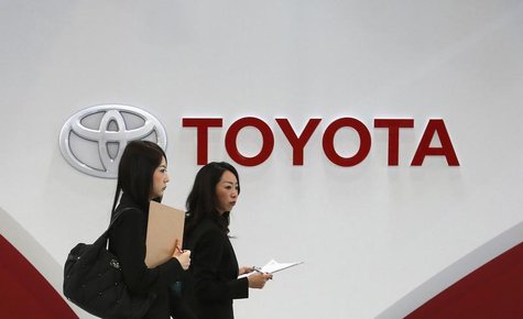 Women walk in front of Toyota Motor's logo at the company's showroom in Tokyo March 12, 2014. REUTERS/Toru Hanai Women walk in front of Toyota Motor's logo at the company's showroom in Tokyo March 12, 2014. REUTERS/Toru Hanai