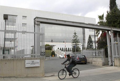 A man cycles pass the Central Bank of Cyprus on the island's capital Nicosia, April 18, 2013. REUTERS/Andreas Manolis A man cycles pass the Central Bank of Cyprus on the island's capital Nicosia, April 18, 2013. REUTERS/Andreas Manolis