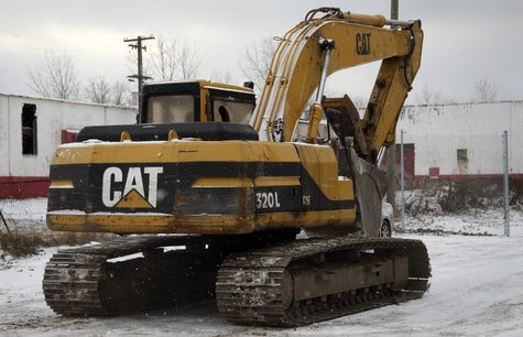 A Caterpillar excavator machine is seen at a work site in Detroit, Michigan January 25, 2013. REUTERS/ Rebecca Cook A Caterpillar excavator machine is seen at a work site in Detroit, Michigan January 25, 2013. REUTERS/ Rebecca Cook