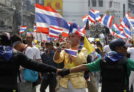 An anti-government protester blows a trumpet during a rally in central Bangkok March 28, 2014. REUTERS/Chaiwat Subprasom An anti-government protester blows a trumpet during a rally in central Bangkok March 28, 2014. REUTERS/Chaiwat Subprasom