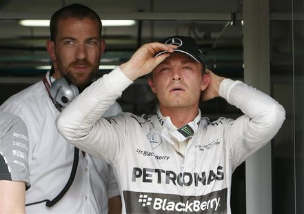 Mercedes Formula One driver Nico Rosberg of Germany adjusts his cap after the second practice session of the Malaysian F1 Grand Prix at Sepa Mercedes Formula One driver Nico Rosberg of Germany adjusts his cap after the second practice session of the Malaysian F1 Grand Prix at Sepa