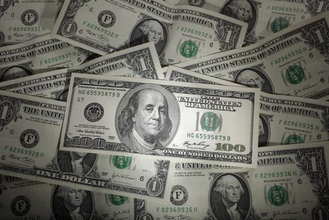 A picture illustration shows a 100 Dollar banknote laying on one Dollar banknotes, taken in Warsaw, January 13, 2011. REUTERS/Kacper Pempel A picture illustration shows a 100 Dollar banknote laying on one Dollar banknotes, taken in Warsaw, January 13, 2011. REUTERS/Kacper Pempel