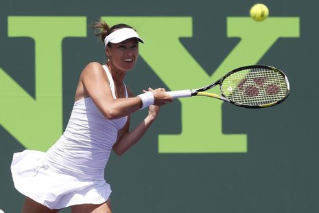 Mar 28, 2014; Miami, FL, USA; Martina Hingis hits a forehand next to partner Sabine Lisicki (not pictured) against Cara Black and Sania Mizr Mar 28, 2014; Miami, FL, USA; Martina Hingis hits a forehand next to partner Sabine Lisicki (not pictured) against Cara Black and Sania Mizr