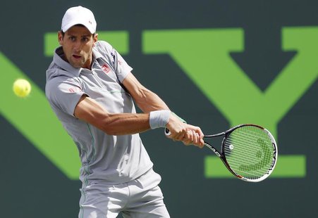 Mar 30, 2014; Miami, FL, USA; Novak Djokovic hits a backhand against Rafael Nadal (not pictured) during the men's singles final of the Sony Mar 30, 2014; Miami, FL, USA; Novak Djokovic hits a backhand against Rafael Nadal (not pictured) during the men's singles final of the Sony