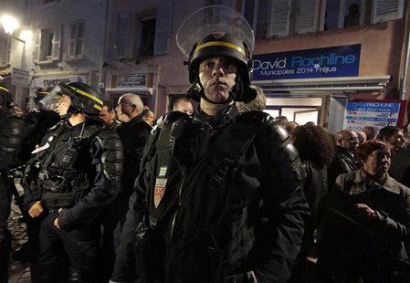 French riot policemen stand guard in front of the campaign headquarters of David Rachline, France's far-right National Front political party French riot policemen stand guard in front of the campaign headquarters of David Rachline, France's far-right National Front political party