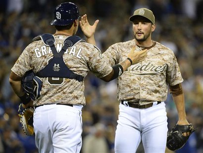 Mar 30, 2014; San Diego, CA, USA; San Diego Padres relief pitcher Huston Street (16) celebrates with catcher Yasmani Grandal (8) after winni Mar 30, 2014; San Diego, CA, USA; San Diego Padres relief pitcher Huston Street (16) celebrates with catcher Yasmani Grandal (8) after winni