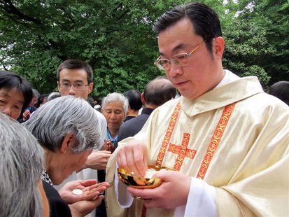 Rev. Thaddeus Ma Daqin gives the holy communion to a woman at Sheshan Cathedral, Shanghai in this April 30, 2012 picture provided to Reuters Rev. Thaddeus Ma Daqin gives the holy communion to a woman at Sheshan Cathedral, Shanghai in this April 30, 2012 picture provided to Reuters
