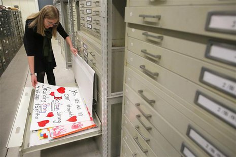 Archivist Marta Crilly looks through a file drawer of posters saved from the makeshift memorial that arose following the 2013 Boston Maratho Archivist Marta Crilly looks through a file drawer of posters saved from the makeshift memorial that arose following the 2013 Boston Maratho
