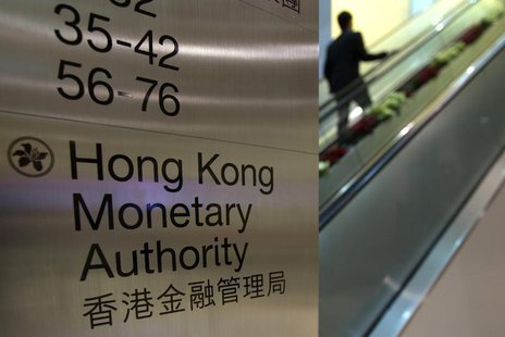 A security guard walks past a directory board of Hong Kong Monetary Authority (HKMA) in Hong Kong December 20, 2012. REUTERS/Tyrone Siu A security guard walks past a directory board of Hong Kong Monetary Authority (HKMA) in Hong Kong December 20, 2012. REUTERS/Tyrone Siu