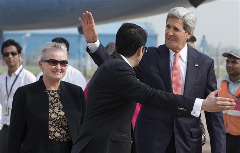 U.S. Secretary of State John Kerry waves in front of U.S. Ambassador to India Nancy Powell (L) upon his arrival in New Delhi in this June 23 U.S. Secretary of State John Kerry waves in front of U.S. Ambassador to India Nancy Powell (L) upon his arrival in New Delhi in this June 23