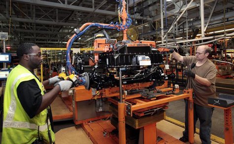 Ford Assembly workers install a battery onto the chassis of a Ford Focus Electric vehicle at the Michigan Assembly Plant in Wayne, Michigan, Ford Assembly workers install a battery onto the chassis of a Ford Focus Electric vehicle at the Michigan Assembly Plant in Wayne, Michigan,