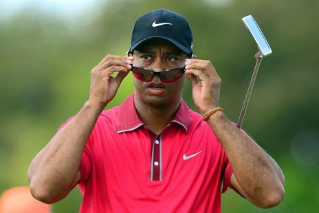 Mar 9, 2014; Miami, FL, USA; Tiger Woods puts on his sunglasses on the 3rd hole green during the final round of the WGC - Cadillac Champions Mar 9, 2014; Miami, FL, USA; Tiger Woods puts on his sunglasses on the 3rd hole green during the final round of the WGC - Cadillac Champions