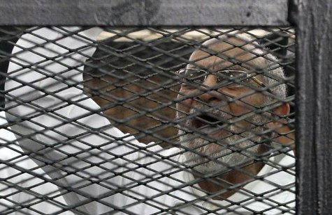 Muslim Brotherhood leader Mohammed Badie shouts slogans from the defendant's cage during his trial with other leaders of the Brotherhood in Muslim Brotherhood leader Mohammed Badie shouts slogans from the defendant's cage during his trial with other leaders of the Brotherhood in