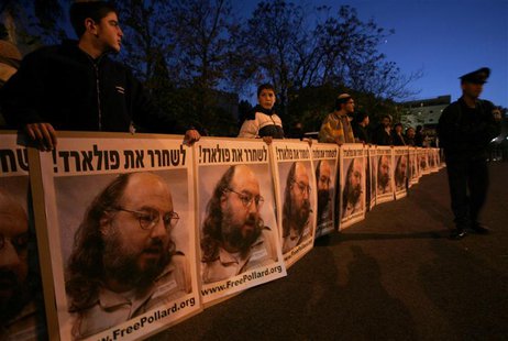 Israeli protesters hold posters calling for the release of Jonathan Pollard, who was imprisoned after being convicted for spying on the Unit Israeli protesters hold posters calling for the release of Jonathan Pollard, who was imprisoned after being convicted for spying on the Unit